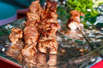 skewers fried meat on a grill
