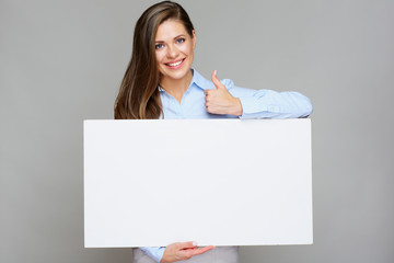 girl holding white big banner and showing thumb up.