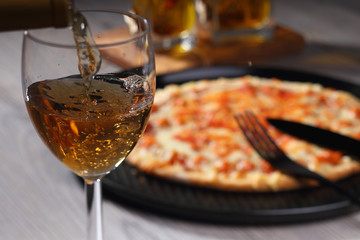 Pouring white wine into glass