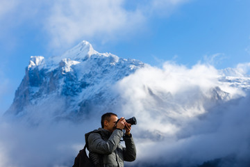 Male photographer taking pictures in Mountains