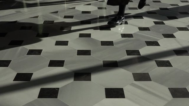 Feet Running Across Marble Floor