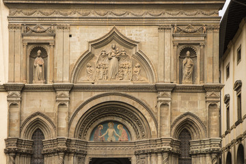 Sculptured religious artwork Front of the Church in Arezzo, Tuscany, Italy
