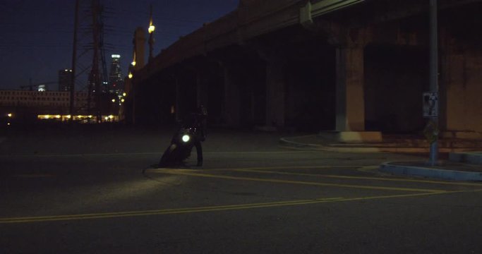 Man on motorcycle makes sharp turn, slow motion