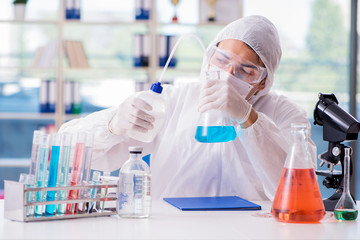 Chemist working in the laboratory with hazardous chemicals