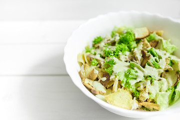 Mixed salad with green apple and walnuts on the table