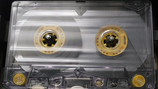  Close-up of played cassette in retro casettophone footage - Supply spindle rotation of music player