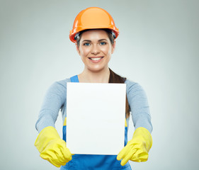 Smiling woman builder holding white banner.