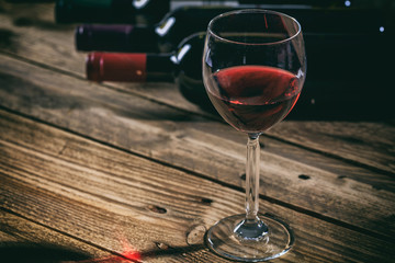 Red wine glass on wooden background