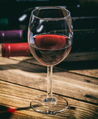 Red wine glass on wooden background