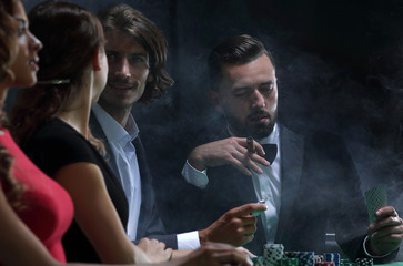 Upper class friends gambling in a casino