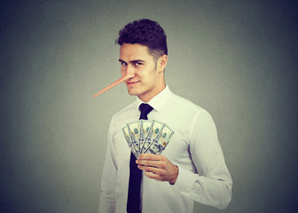 Financial fraud concept. Liar business man with dollar cash
