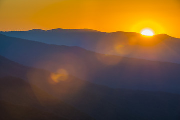 Fototapeta na wymiar Glorious Sunrise over the Great Smoky Mountains layered blue ridges to the orange yellow horizon