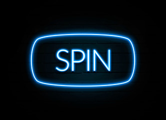 Spin  - colorful Neon Sign on brickwall