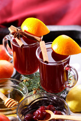 Christmas mulled wine in water, mulled wine with cinnamon and anise, drink with honey, mulled wine glass with seashells in water, retro style, drink with orange slices