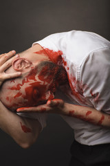 white bold bearded Caucasian male model guy man attractive wearing white shirt and black pants with red face paint makeup