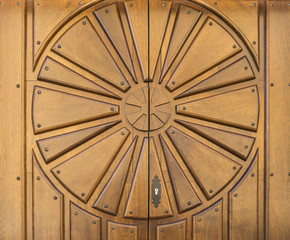brown wooden door with a circle in relief