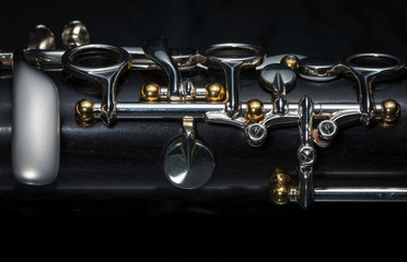 Details of a clarinet with silver keys and golden sockets - obrazy, fototapety, plakaty