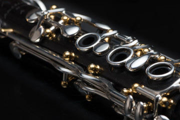 Obraz premium Details of a clarinet with silver keys and golden sockets