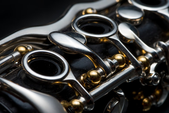 Details of a clarinet with silver keys and golden sockets