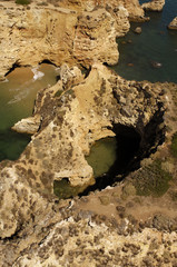 Rock pinnacles and cliffs on the coast line near Praia Da Rocha, Portimão in the Algarve, Portugal.