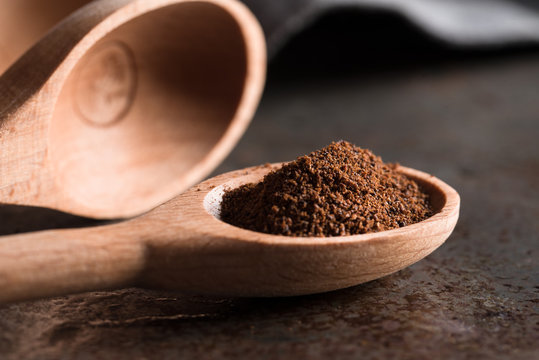 Ground cloves in wood measuring spoon