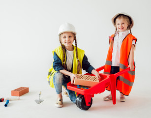 Little girls on the white background. Construction