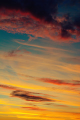 Photo of orange sunset with dark clouds on sky