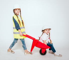 Little girls on the white background. Construction