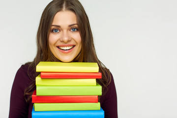 Close up portrait of student girl with books pile.
