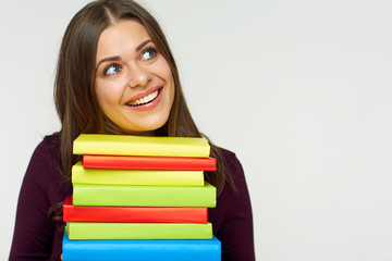 smiling student girl holding pile, stack of books.