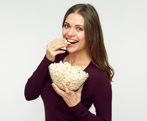 Beautiful woman with long hair eating pop corn.