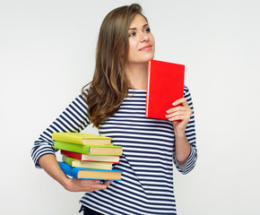 Smiling woman holding book pile.