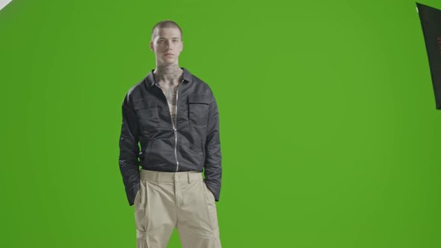 Handsome stylish fashion model - neck tattoo - male fashion model greenscreen - Fashion shot