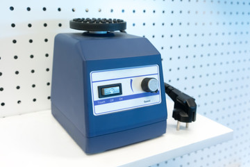 Scientific mixer with flask adapter isolated on floating shelf