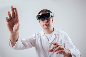 Doctor uses augmented reality goggles.