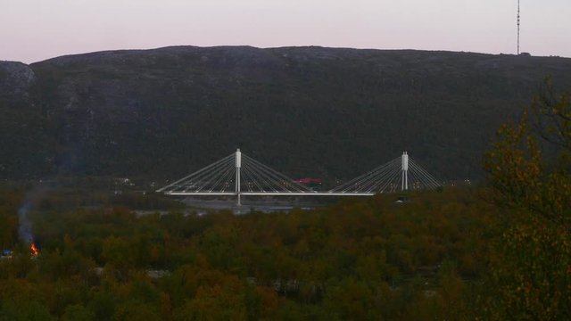 White bridge, Zoom out time lapse of the border bridge between norway and utsjoki town, on a sunny autumn day, Lapland, Lappi, Finland