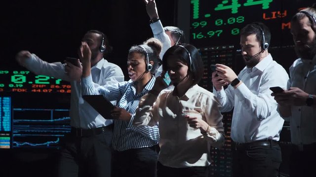 Multiracial people with headset carrying on active dealing working together in office of exchange. - Powered by Adobe