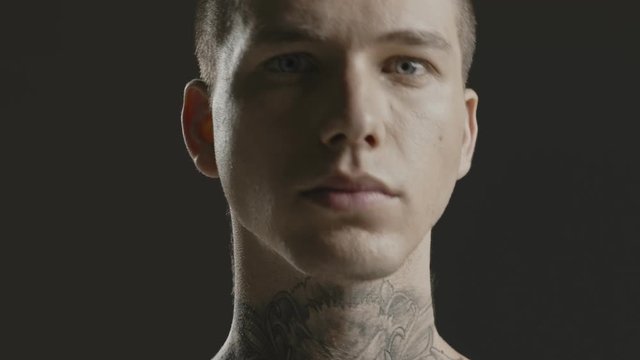 Handsome sexy young man stylish with tattoo on his neck, torso and hand - ultra close up body and face detail - greenscreen Prores - cinematic lighting