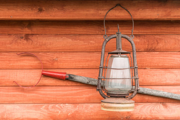 on a wooden wall hanging tongs for pot and lamp