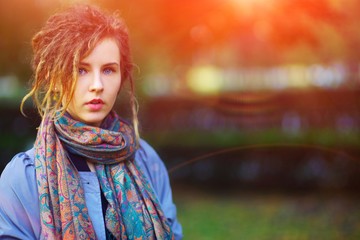 Portrait of young beautiful successful girl in scarf outdoors, closeup