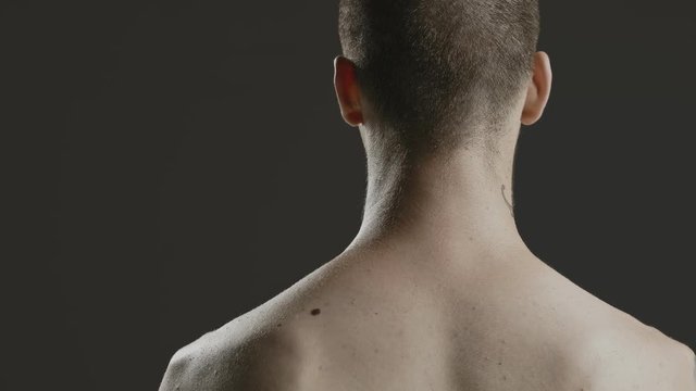 Handsome sexy young man stylish with tattoo on his neck, torso and hand - middle shot portrait studio - Prores - cinematic fashion lighting