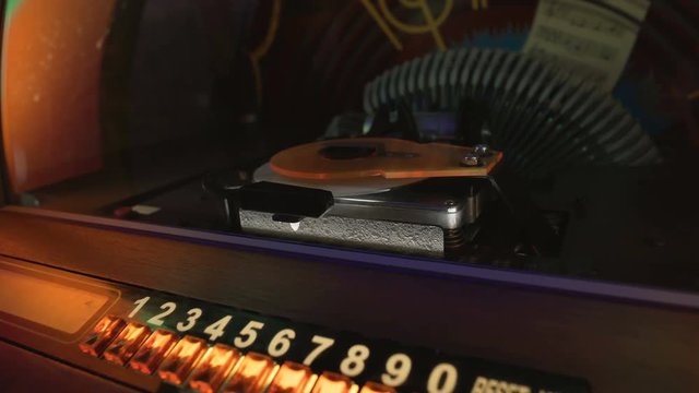 Old jukebox automatically playing selected musical records in pub, retro party
