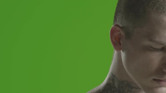 Handsome sexy young man stylish with tattoo on his neck, torso and hand - ultra close up - greenscreen Prores - cinematic lighting