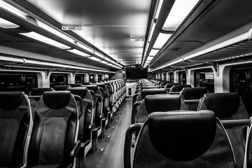 Obraz premium Dover, NJ USA - November 1, 2017: New double-decker NJ Transit train at night with empty seats, black and white