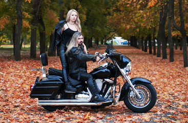 Fototapeta na wymiar Couple on a bike in a leather jackets 