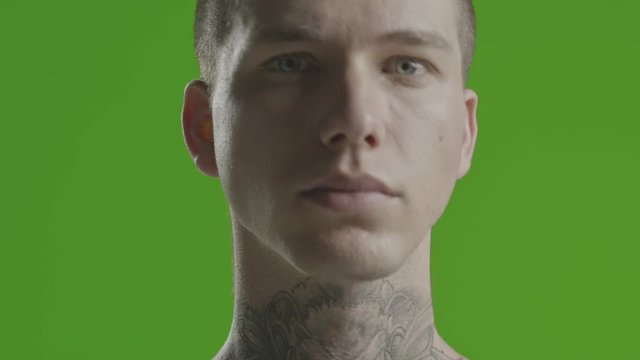 Handsome sexy young man stylish with tattoo on his neck, torso and hand - ultra close up - greenscreen Prores - cinematic lighting