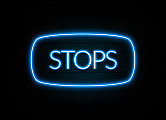 Stops  - colorful Neon Sign on brickwall