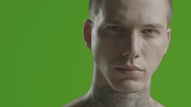 Handsome sexy young man stylish with tattoo on his neck, torso and hand - ultra close up - greenscreen Prores - cinematic lighting