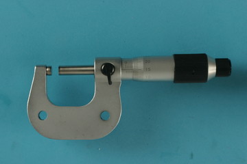 Metric micrometer on Blue background