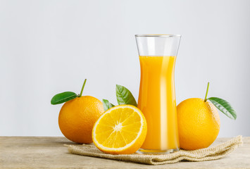 Glass of fresh orange juice on wooden table, Fresh fruits Orange juice in glass with group of orange on white background, Selective focus on glass, isolate white background